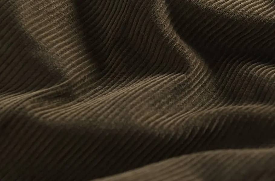 mens-moss-green-corduroy-trousers-fabric-detail.webp
